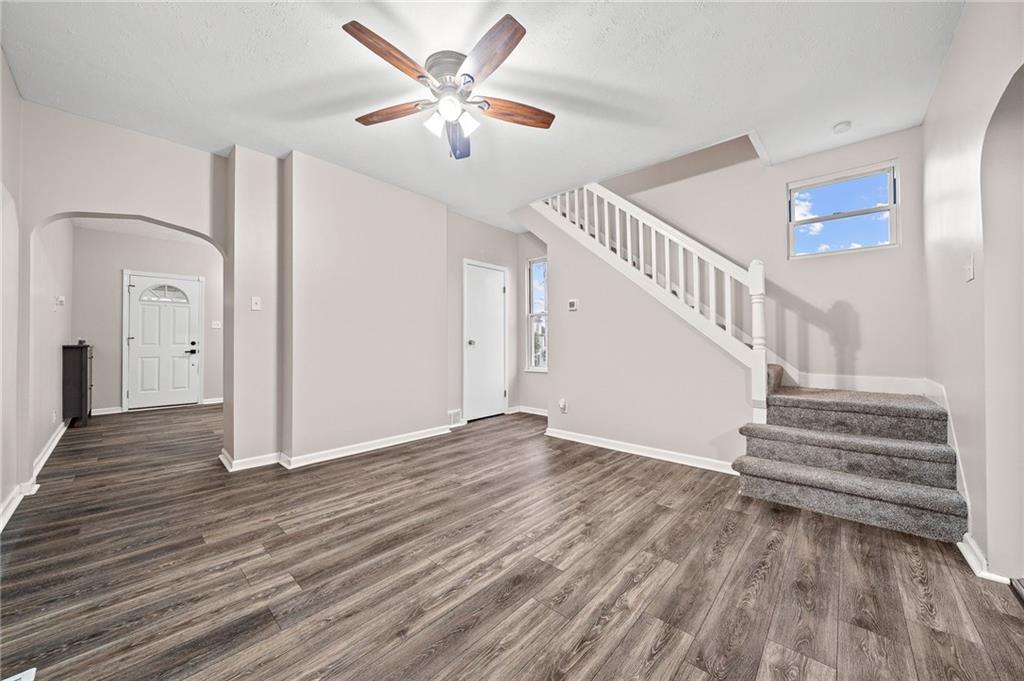 145 Lawrence Avenue Washington, PA 15301 - Photo 5 of 32 a view of an empty room wooden floor and a ceiling fan