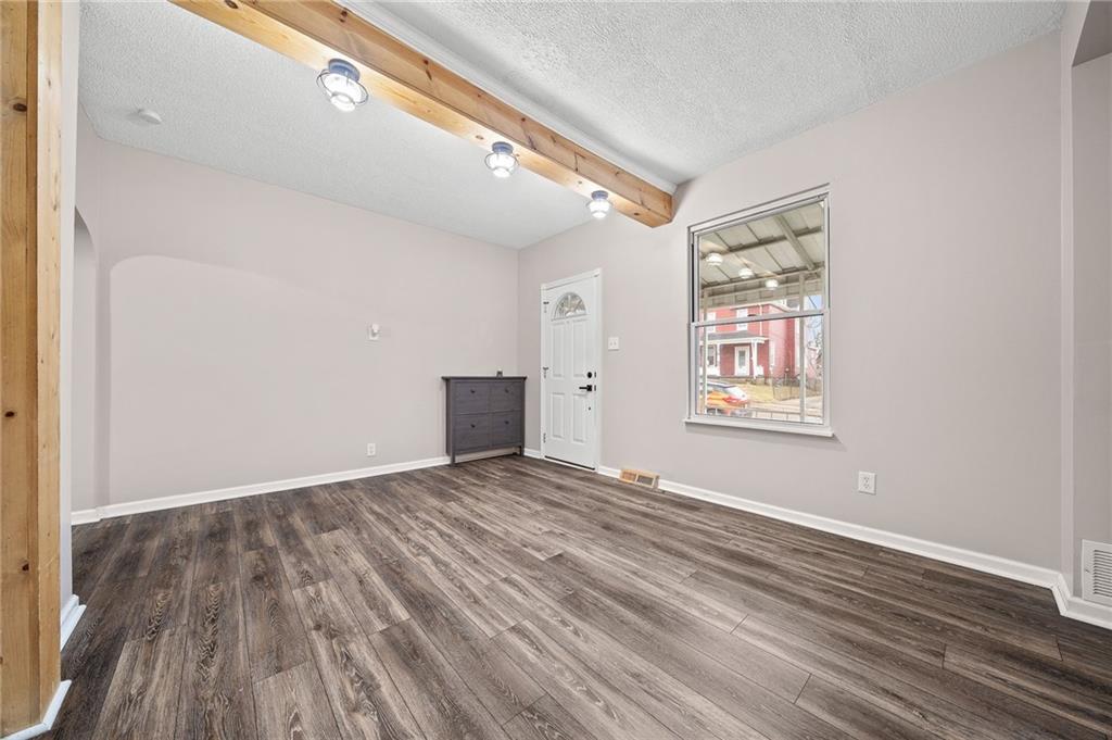 145 Lawrence Avenue Washington, PA 15301 - Photo 9 of 32 a view of an empty room with wooden floor and a window