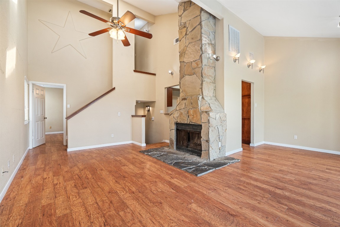 a view of a livingroom with wooden floor and a ceiling fan