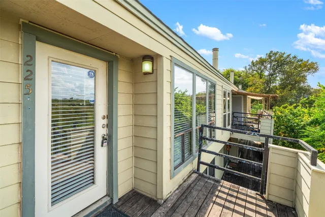 a view of a balcony with furniture and floor to ceiling window