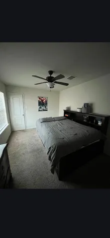 a bedroom with a bed and cabinets
