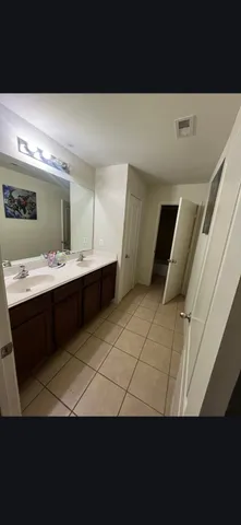 a view of a bathroom with sink and mirror