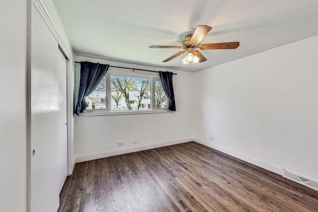 509 North Willow Road Elmhurst, IL 60126 - Photo 6 of 17 an empty room with wooden floor fan and windows