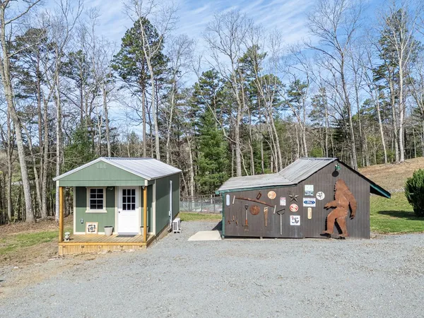 a view of a house with backyard and sitting area