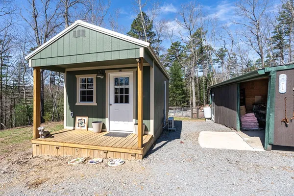 a view of a house with a yard and sitting area