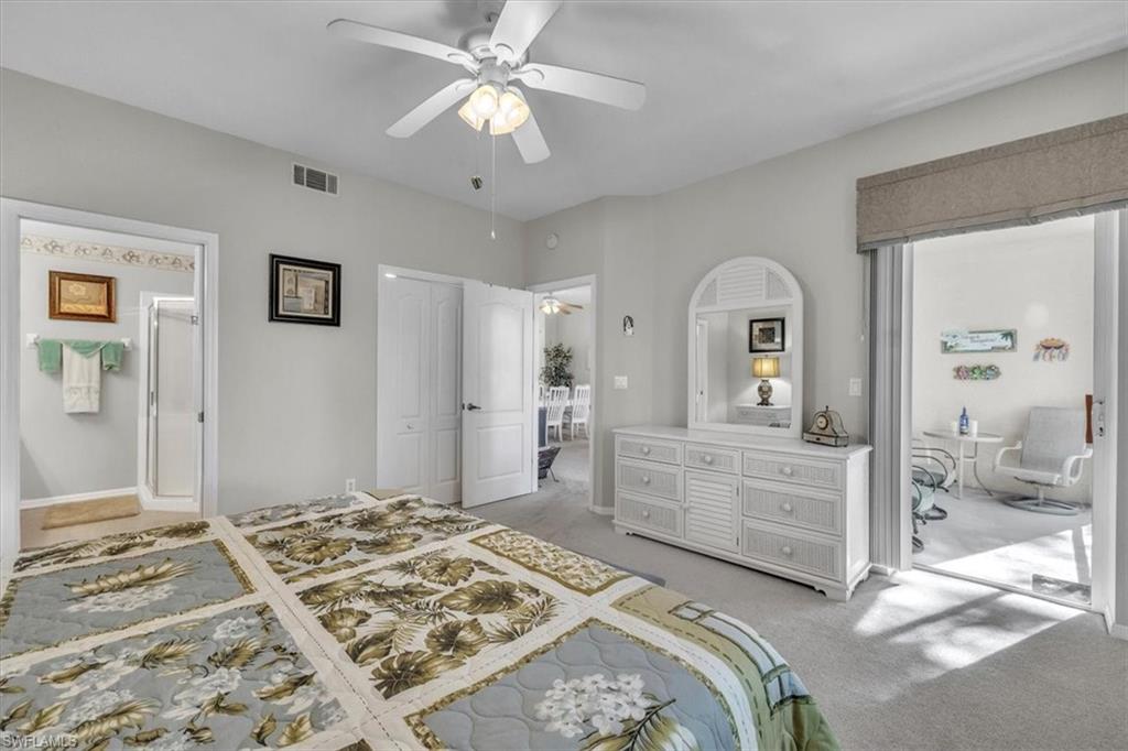 8075 Tiger Cove, Unit 1706 Naples, FL 34113 - Photo 18 of 50 Bedroom featuring light colored carpet, a ceiling fan, and a closet