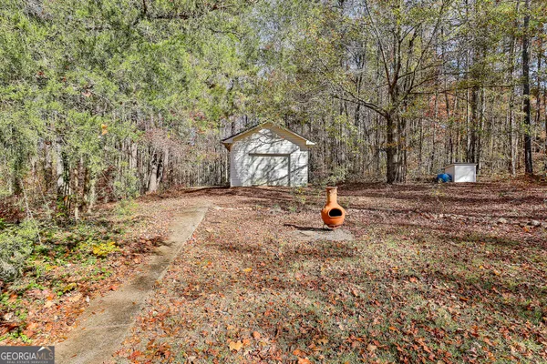 a backyard of a house with barbeque oven and outdoor seating