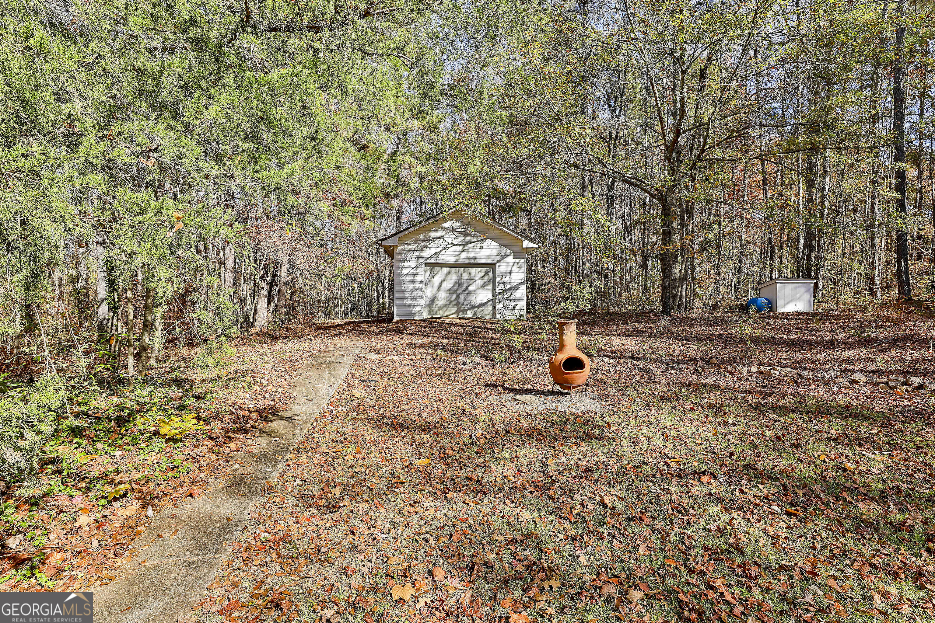 2246 Concord Road Concord, GA 30206 - Photo 13 of 18 a backyard of a house with barbeque oven and outdoor seating