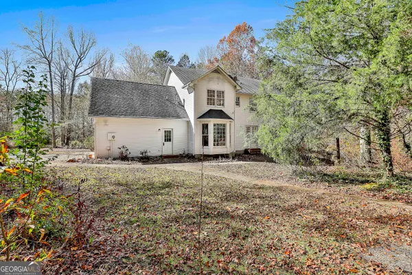 a view of a white house with a yard