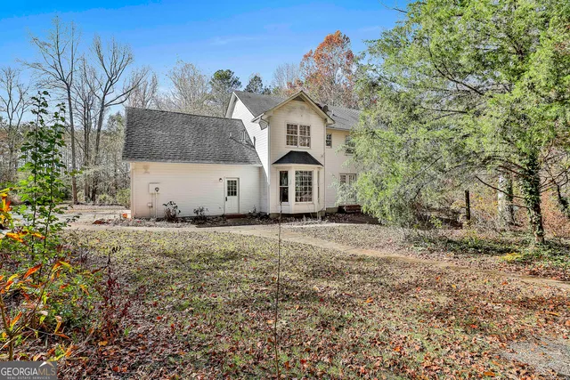a view of a white house with a yard