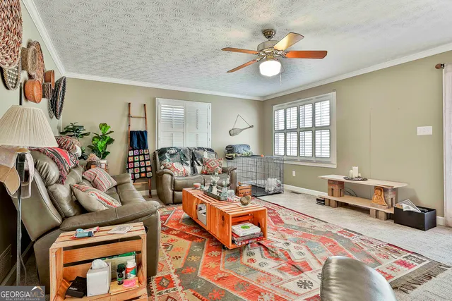a living room with furniture and a chandelier