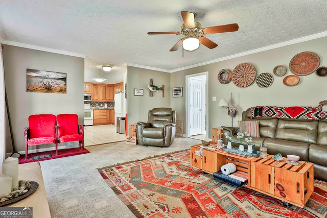 a living room with blue lights with furniture and kitchen view