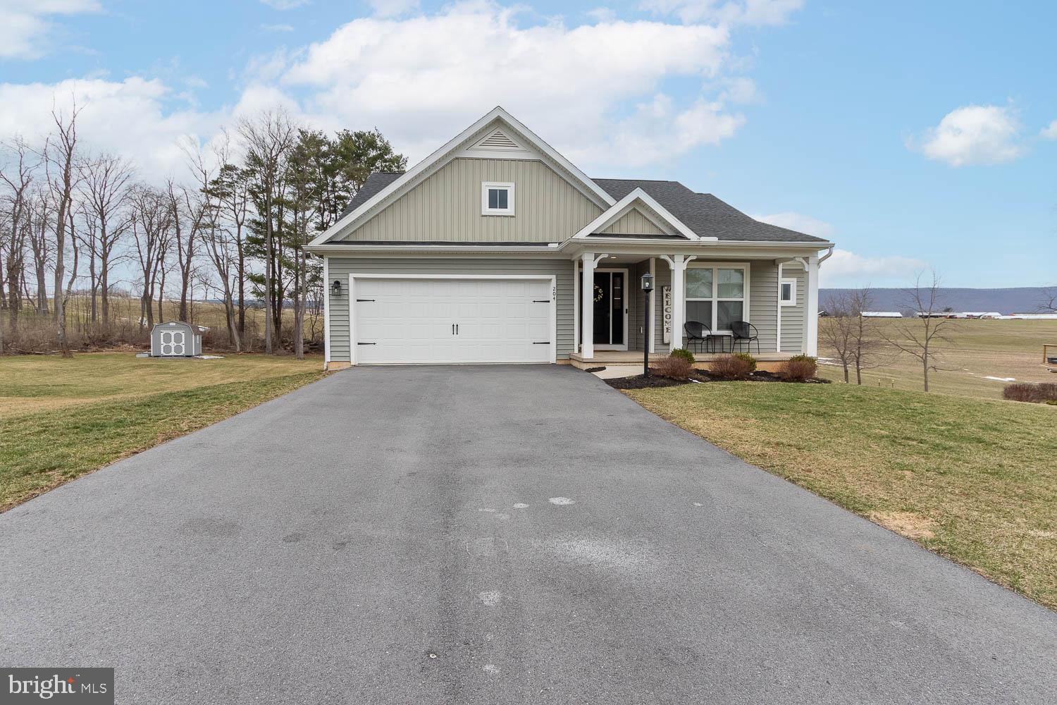 204 Whitetail Circle Mill Hall, PA 17751 - Photo 33 of 33 a front view of a house with a yard and garage