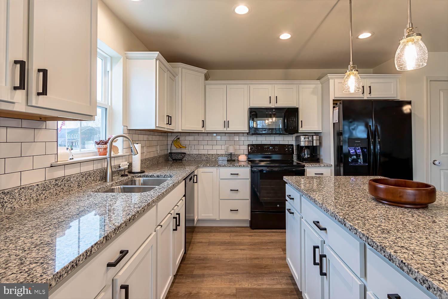204 Whitetail Circle Mill Hall, PA 17751 - Photo 8 of 33 a kitchen with granite countertop a sink a counter top space appliances and cabinets