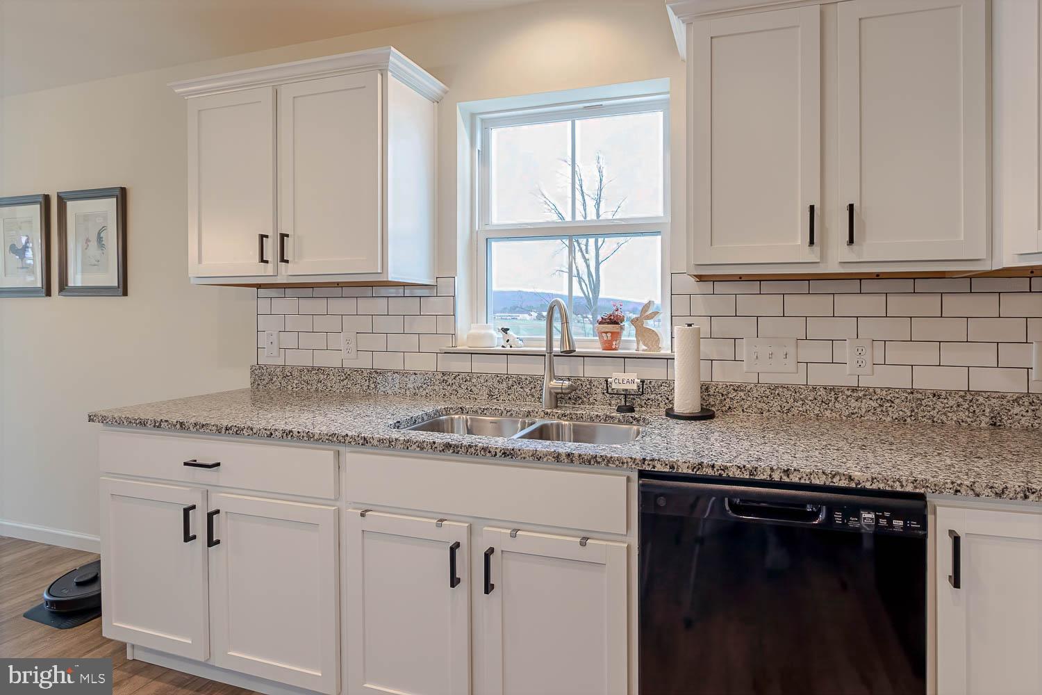 204 Whitetail Circle Mill Hall, PA 17751 - Photo 9 of 33 a kitchen with granite countertop white cabinets and a sink