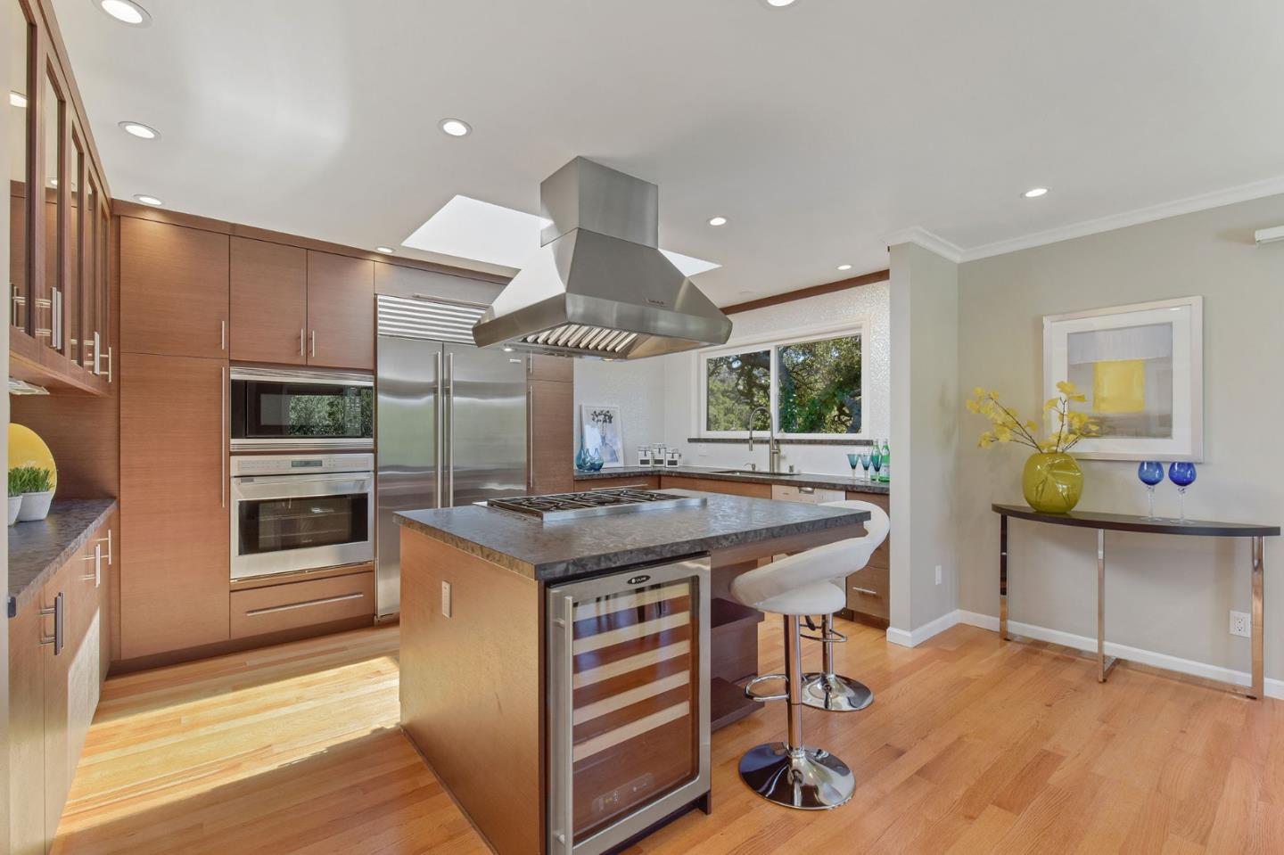 39 Colorados Drive Millbrae, CA 94030 - Photo 11 of 49 a kitchen with stainless steel appliances granite countertop a stove and cabinets