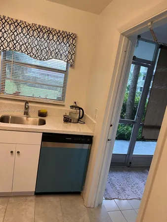 a kitchen with a sink and wooden cabinets