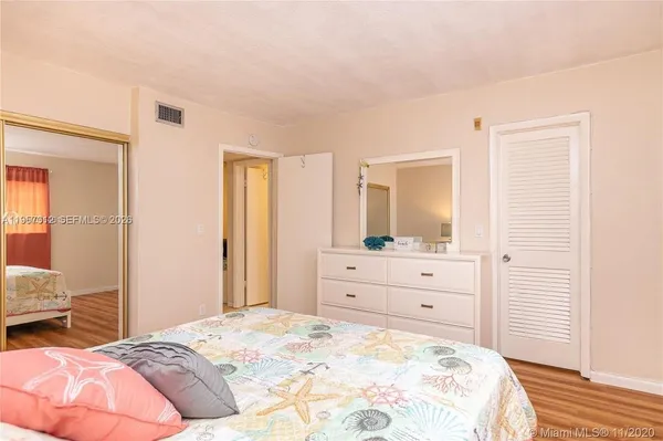 a bedroom with a bed and a mirror