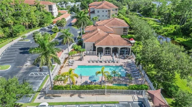 an aerial view of a house with yard swimming pool and outdoor seating