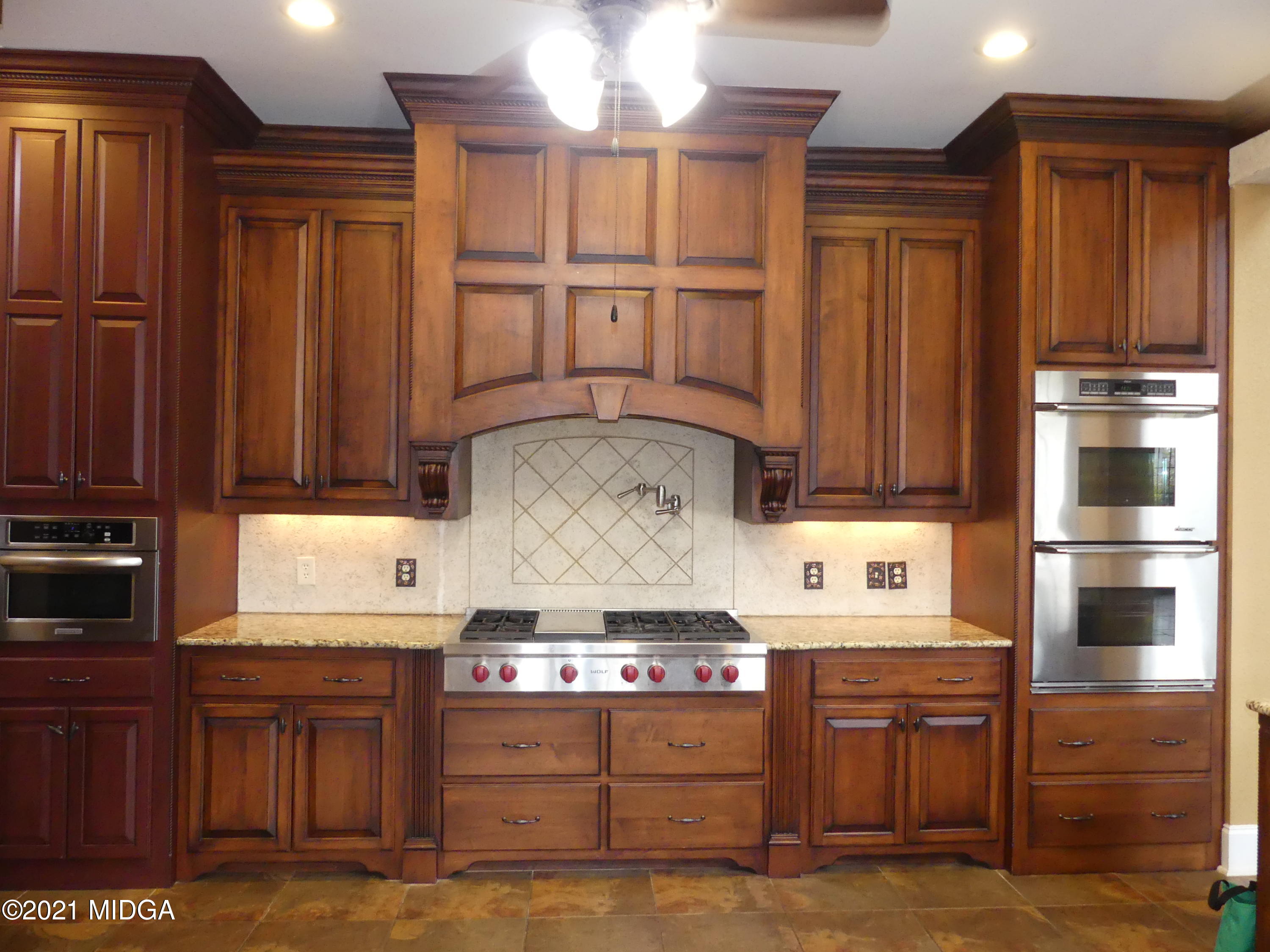 1616 Wadley Road Macon, GA 31220 - Photo 12 of 56 a kitchen with stainless steel appliances wooden cabinets and stove