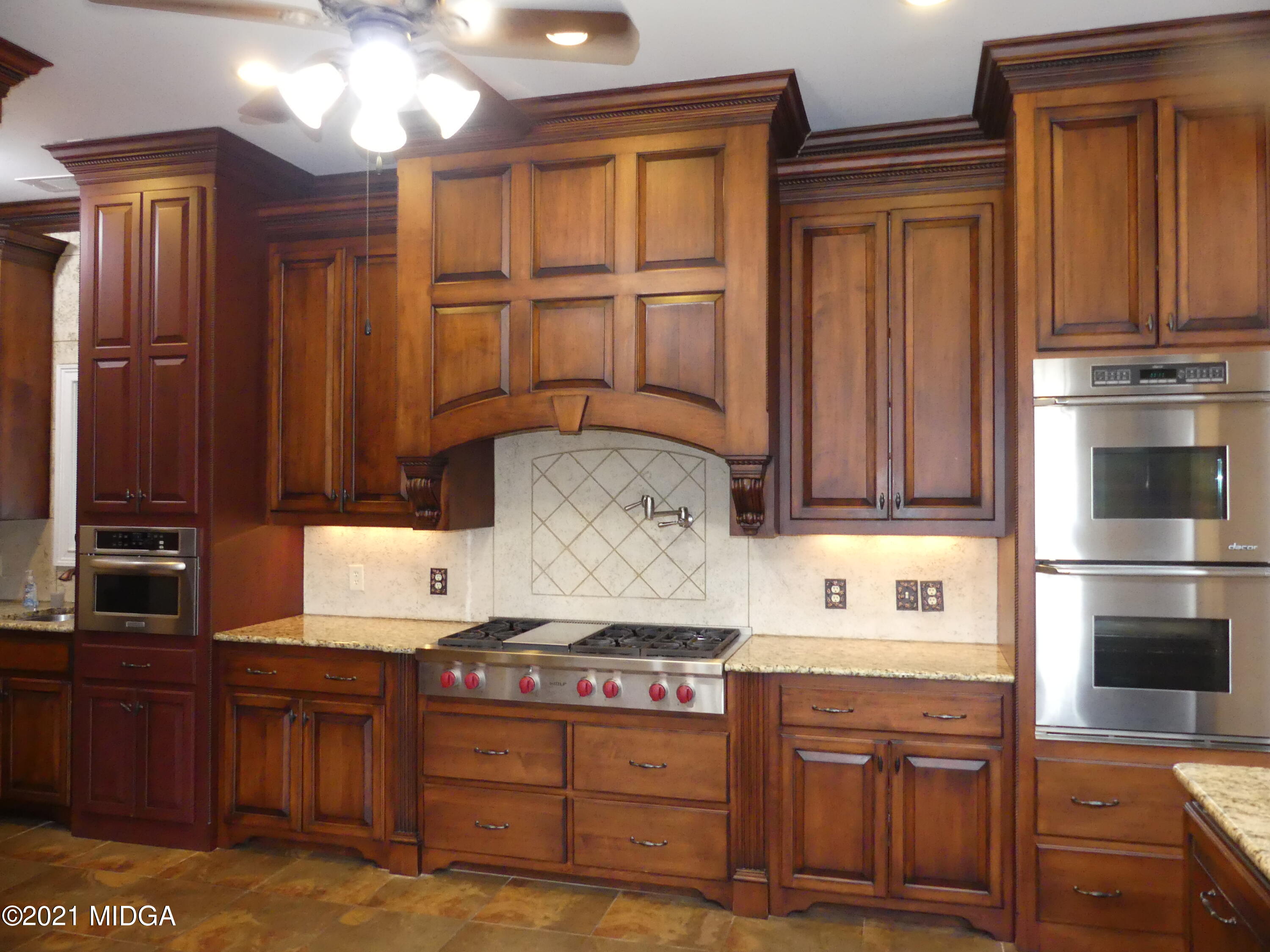 1616 Wadley Road Macon, GA 31220 - Photo 13 of 56 a kitchen with stainless steel appliances granite countertop wooden cabinets a stove top oven a sink and dishwasher