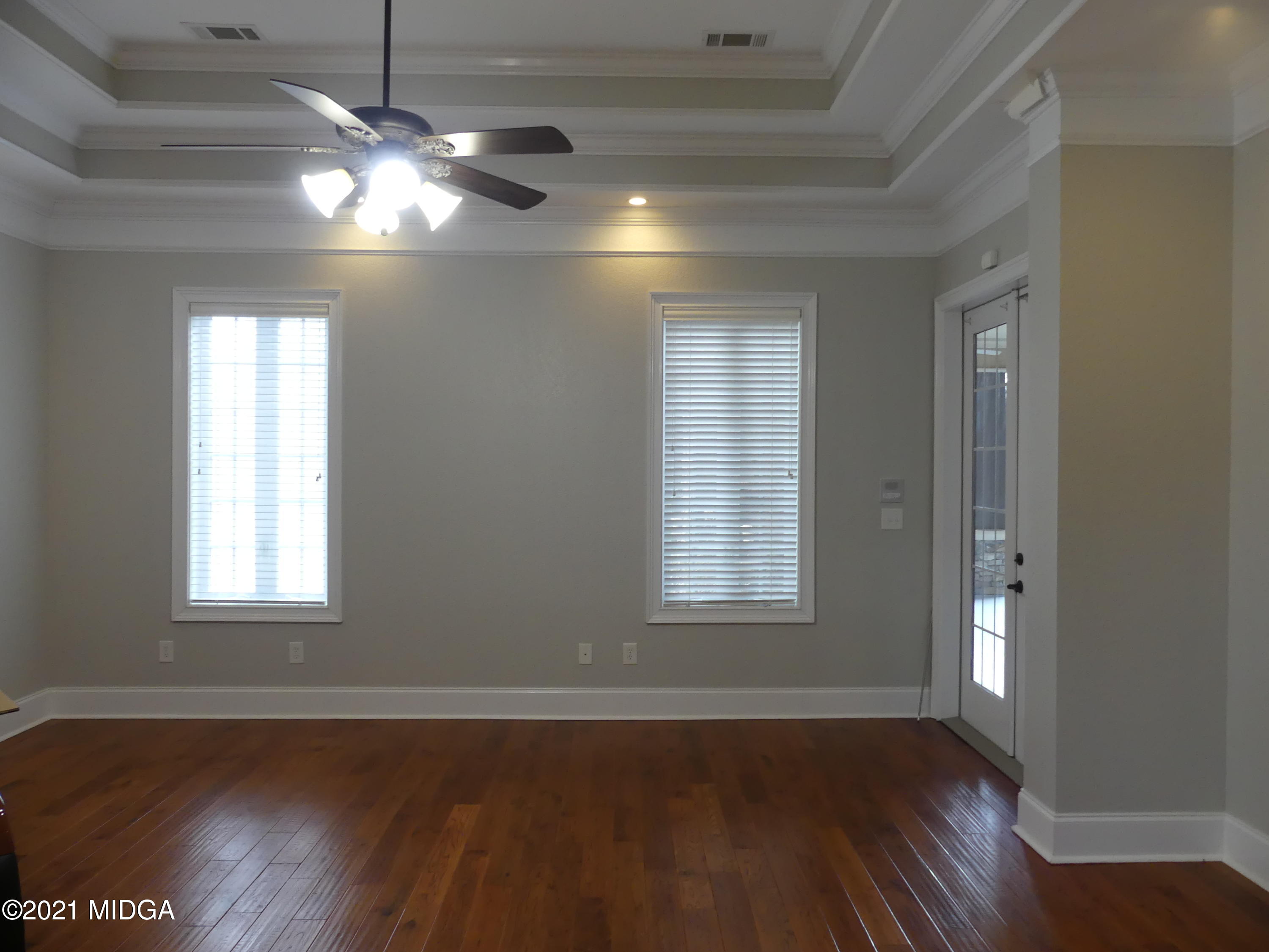 1616 Wadley Road Macon, GA 31220 - Photo 23 of 56 an empty room with wooden floor and windows