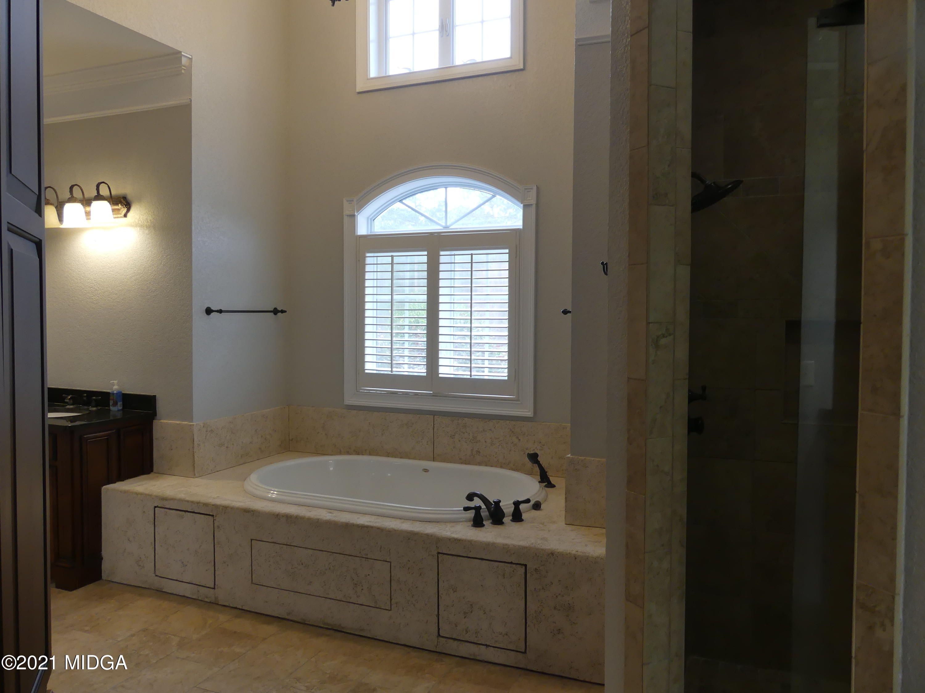 1616 Wadley Road Macon, GA 31220 - Photo 26 of 56 a spacious bathroom with a bathtub and a window