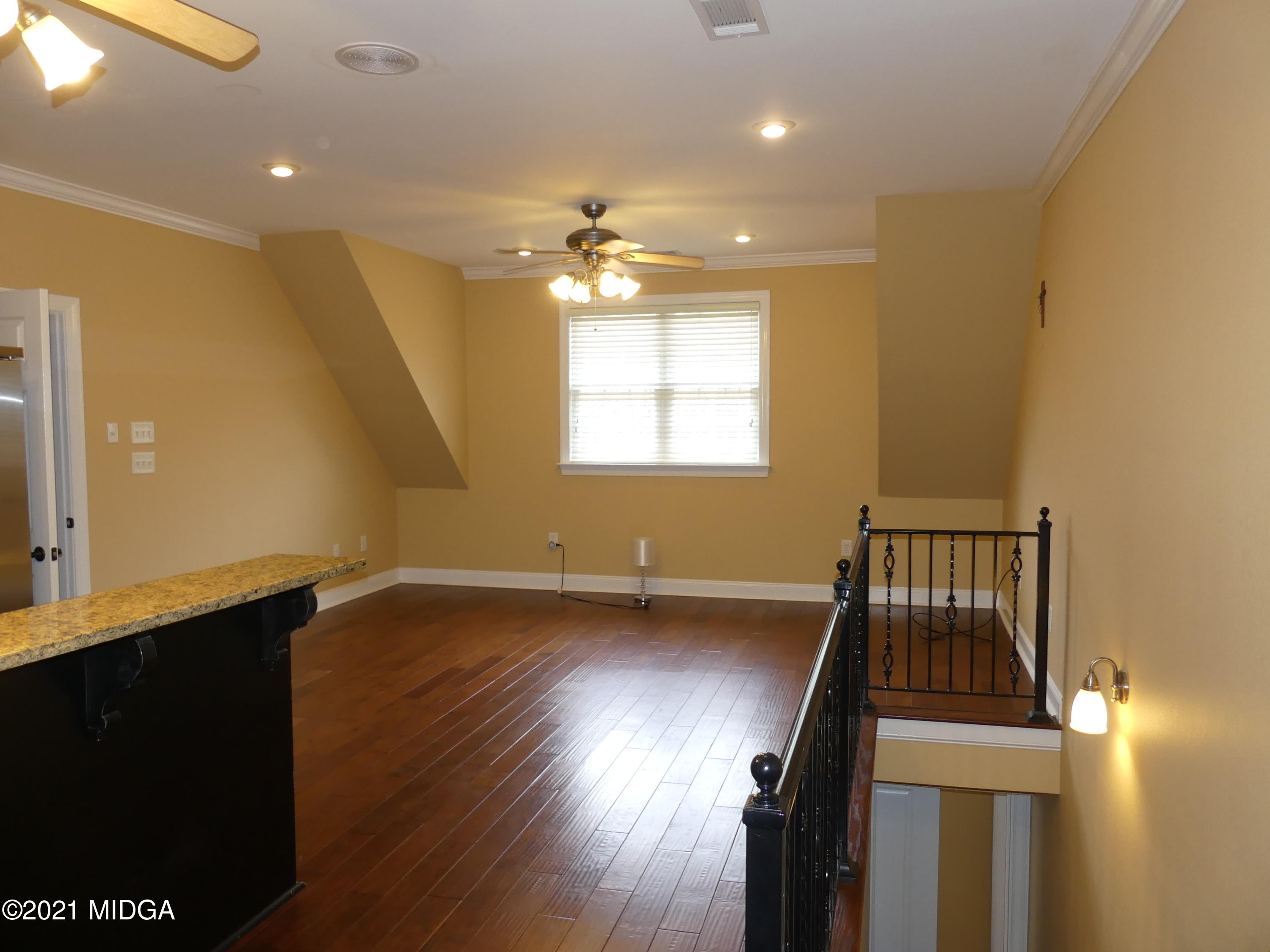 1616 Wadley Road Macon, GA 31220 - Photo 42 of 56 a view of an empty room with window and wooden floor
