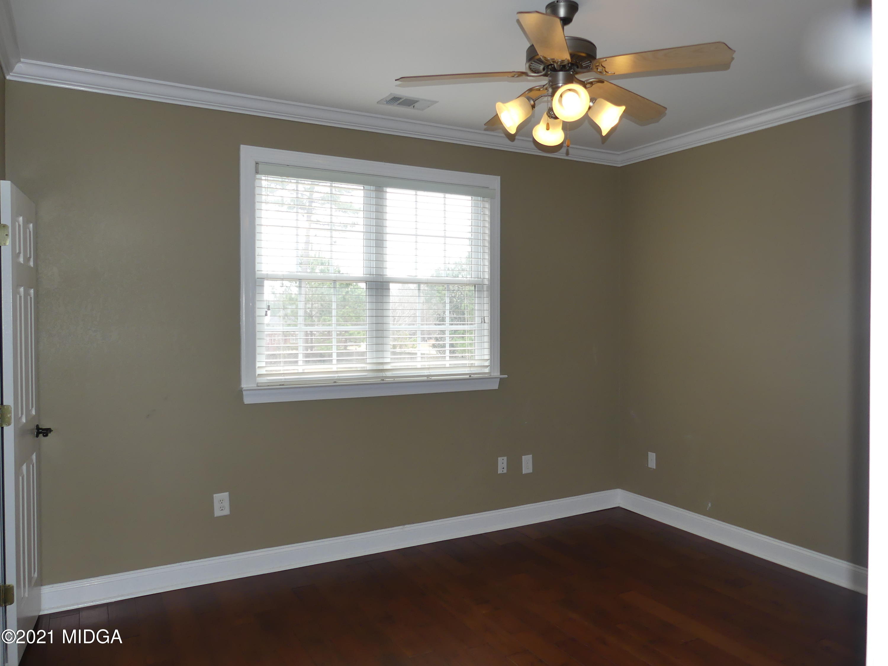 1616 Wadley Road Macon, GA 31220 - Photo 44 of 56 a view of an empty room with wooden floor and a window
