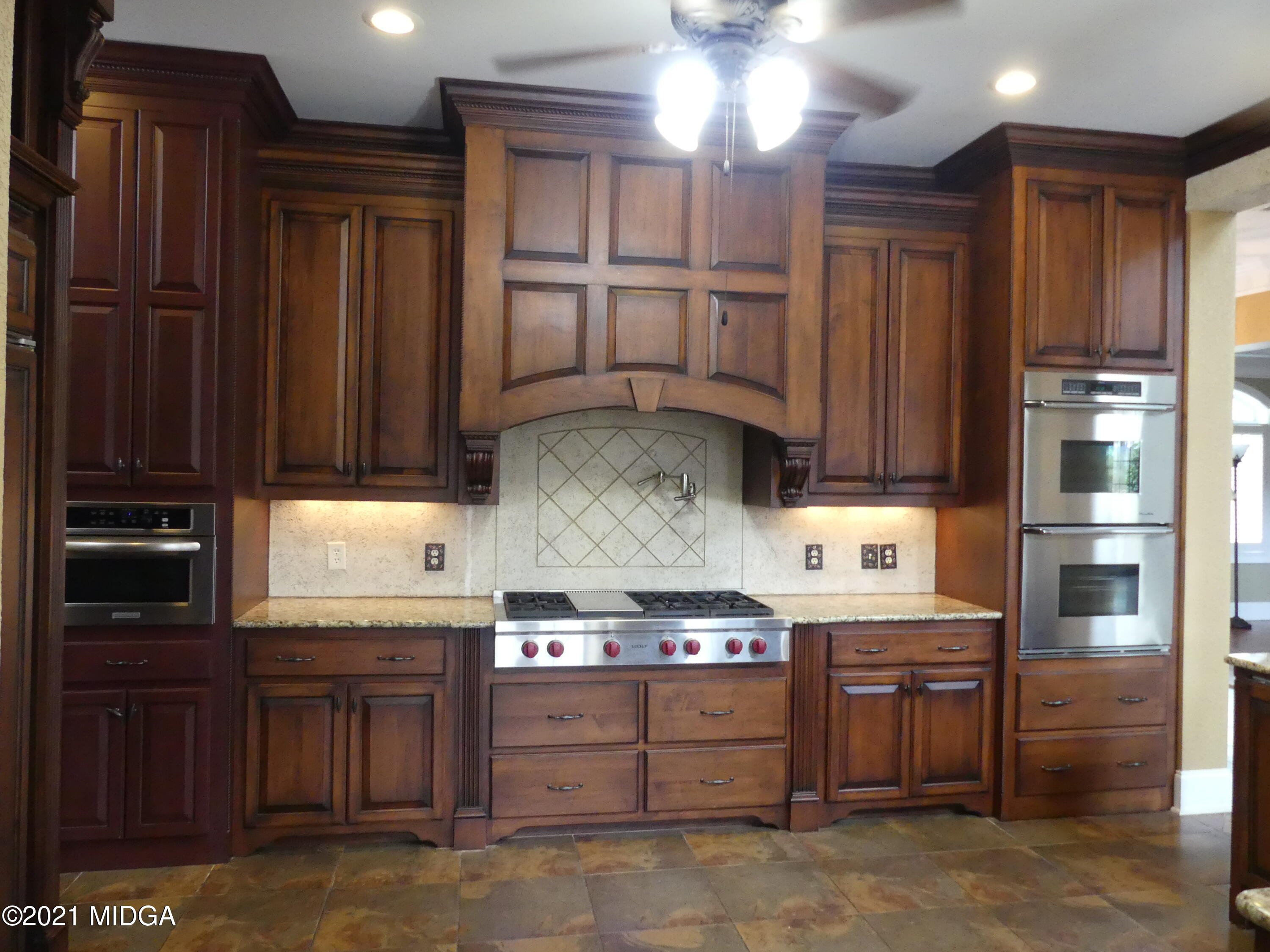 1616 Wadley Road Macon, GA 31220 - Photo 8 of 56 a kitchen with stainless steel appliances granite countertop wooden cabinets a stove top oven and sink