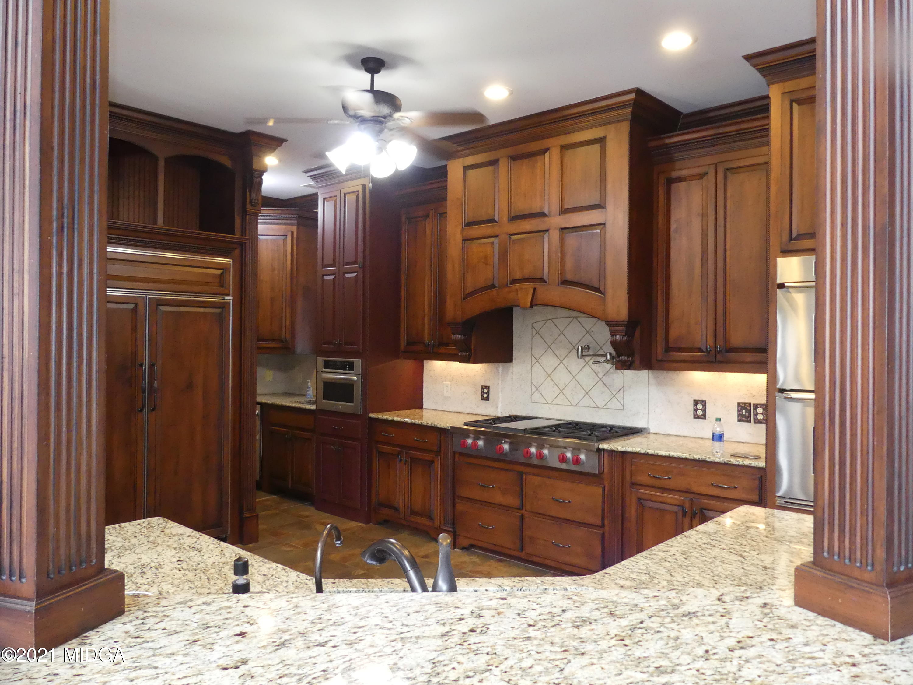 1616 Wadley Road Macon, GA 31220 - Photo 9 of 56 a kitchen with kitchen island granite countertop a sink cabinets and stainless steel appliances