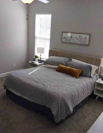 a bedroom with a bed and window