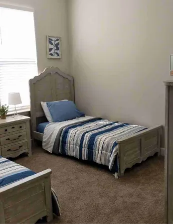 a bedroom with a bed and a window