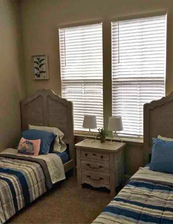 a bedroom with a bed and windows