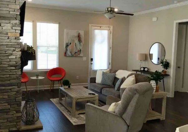 a living room with furniture a window and gym equipment