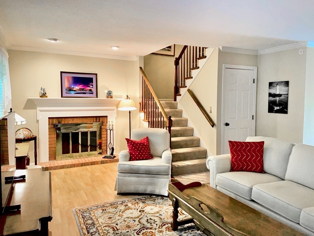 149 The Meadows, Unit 149 Enfield, CT 06082 - Photo 6 of 14 a living room with furniture and a fireplace