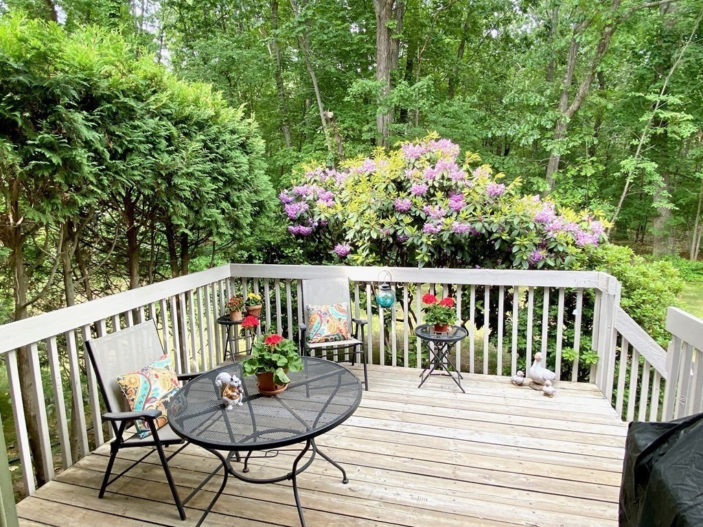 149 The Meadows, Unit 149 Enfield, CT 06082 - Photo 7 of 14 a view of a balcony with wooden floor and outdoor seating
