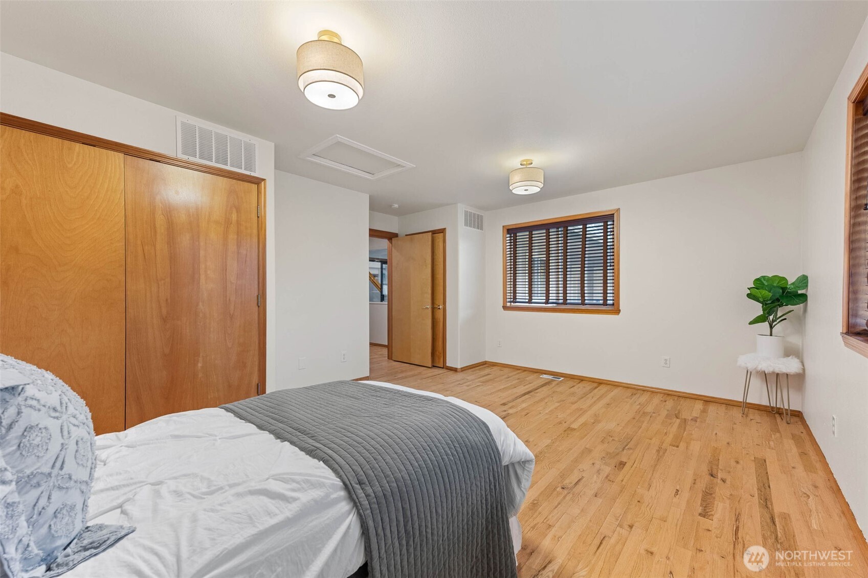 30608 40th Avenue South Roy, WA 98580 - Photo 24 of 40 a bedroom with a large bed and a chandelier