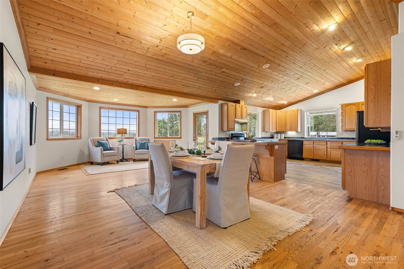 30608 40th Avenue South Roy, WA 98580 - Photo 10 of 40 a living room with couches a barbecue dining table and chairs with outer view