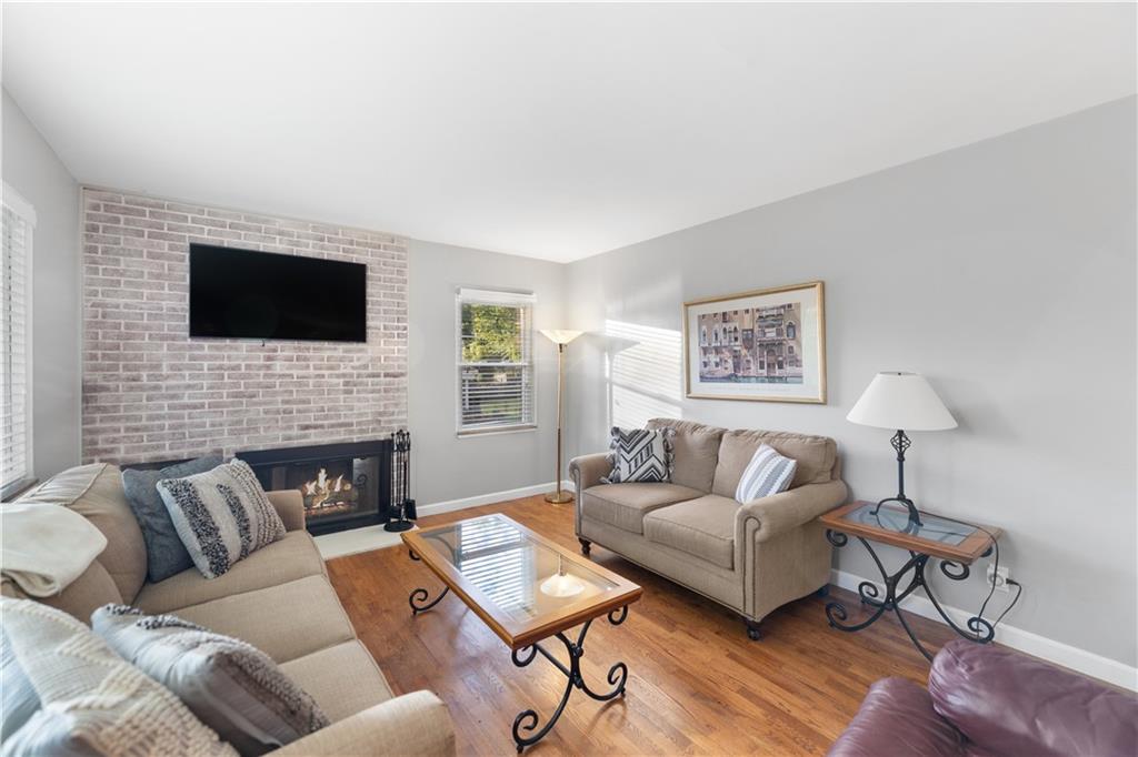 3318 Ivanhoe Road Pittsburgh, PA 15241 - Photo 13 of 45 a living room with furniture a fireplace and a flat screen tv