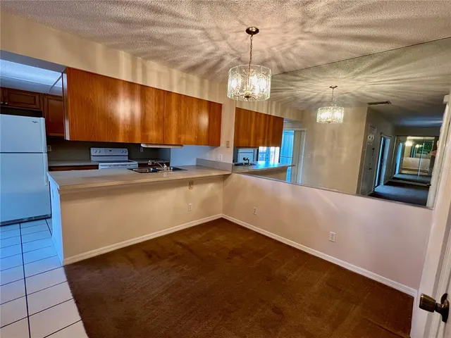 a kitchen with stainless steel appliances granite countertop a sink a stove and a refrigerator