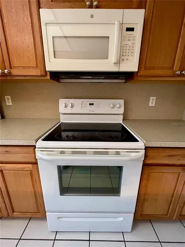 a stove top oven sitting inside of a kitchen