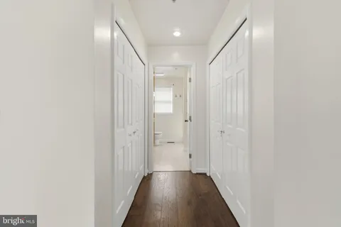 a view of a hallway with wooden floor