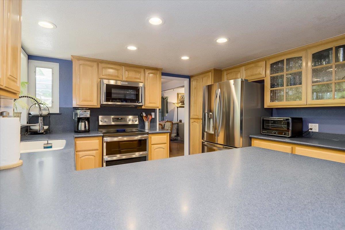 1635 Serpa Drive Milpitas, CA 95035 - Photo 11 of 31 a large kitchen with stainless steel appliances granite countertop a refrigerator a stove and a sink with wooden floor