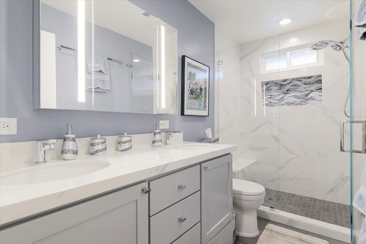 1635 Serpa Drive Milpitas, CA 95035 - Photo 22 of 31 a bathroom with a granite countertop sink a toilet and a shower