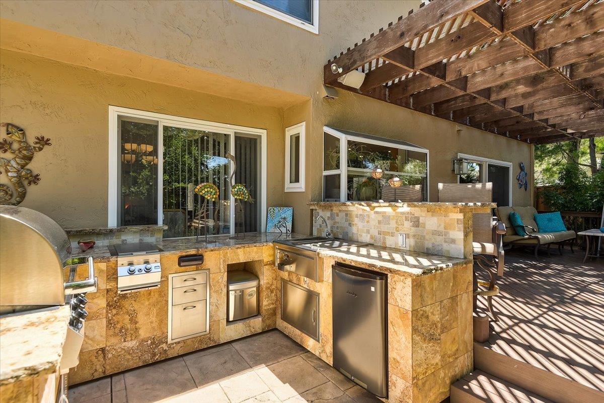 1635 Serpa Drive Milpitas, CA 95035 - Photo 26 of 31 a kitchen with stainless steel appliances granite countertop a stove and a white cabinets