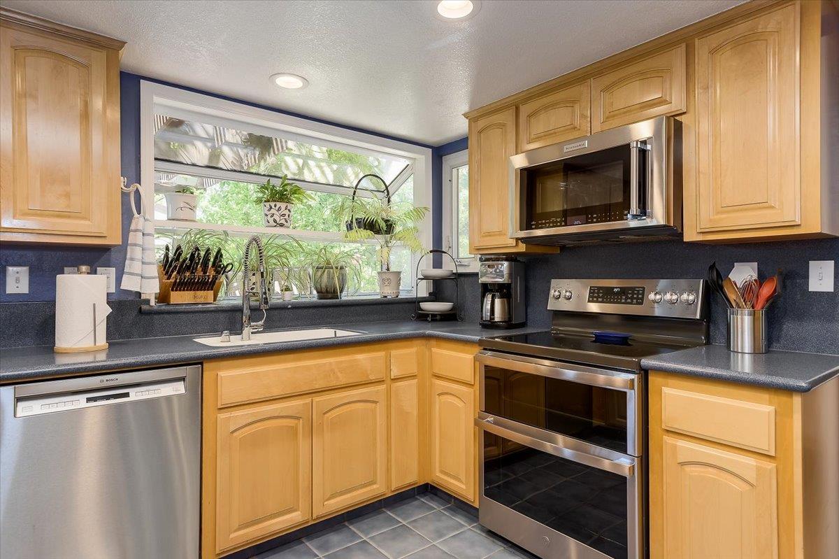 1635 Serpa Drive Milpitas, CA 95035 - Photo 10 of 31 a kitchen with stainless steel appliances granite countertop a stove a sink and a microwave