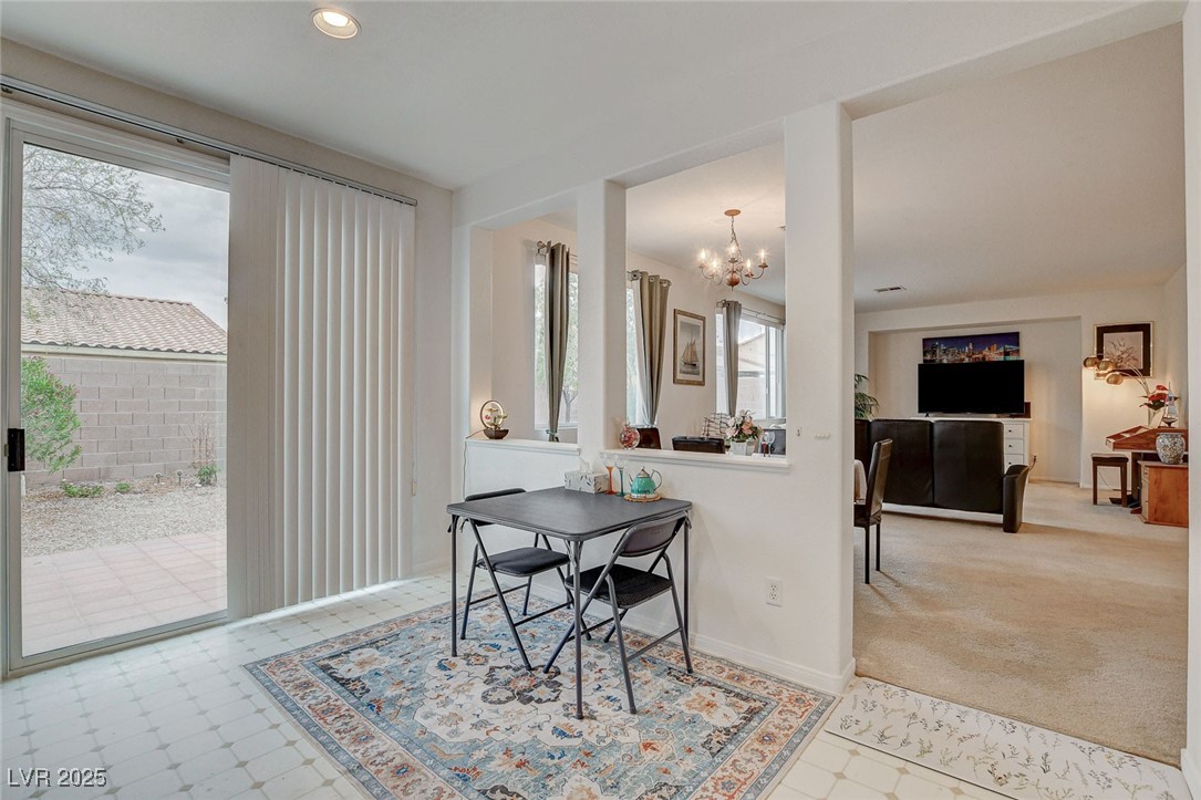7427 Wagonwheel Ranch Way Las Vegas, NV 89113 - Photo 17 of 50 Carpeted dining area with a chandelier, recessed lighting, and tile patterned floors