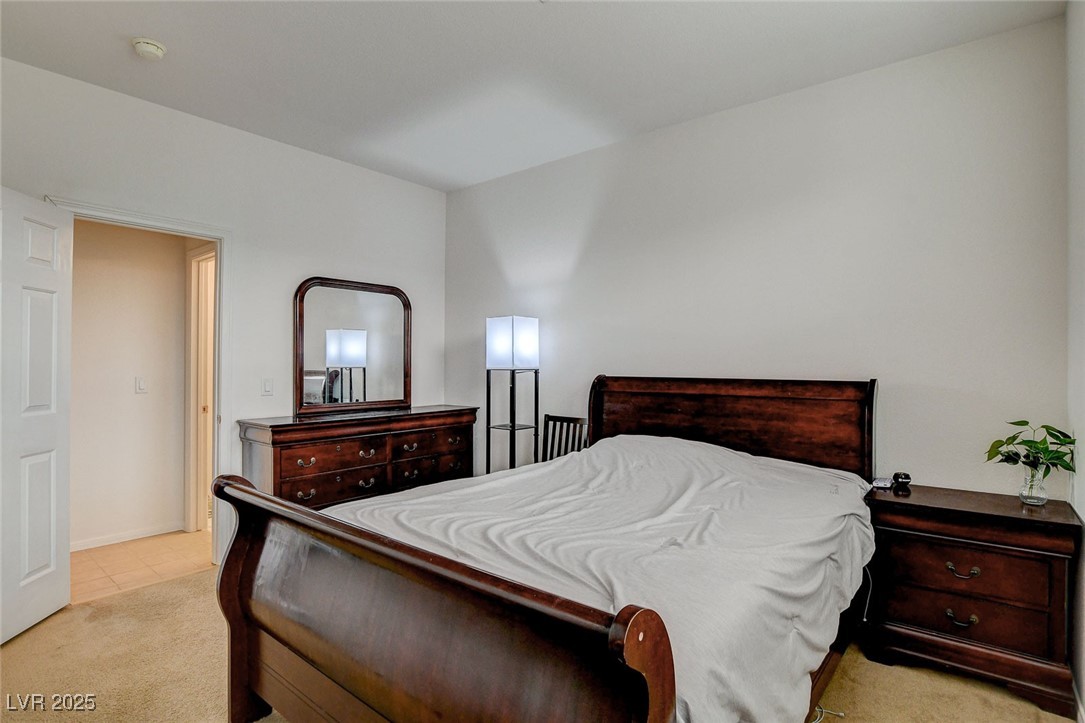 7427 Wagonwheel Ranch Way Las Vegas, NV 89113 - Photo 19 of 50 Carpeted bedroom featuring tile patterned floors