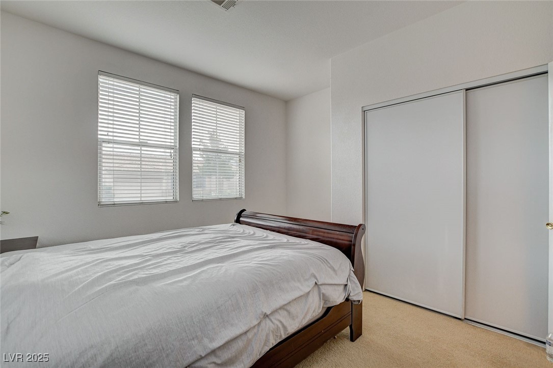 7427 Wagonwheel Ranch Way Las Vegas, NV 89113 - Photo 20 of 50 Bedroom with light carpet and a closet